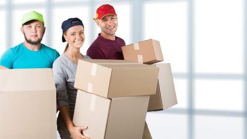 Movers handling desks and equipment during an office move in Notting Hill
