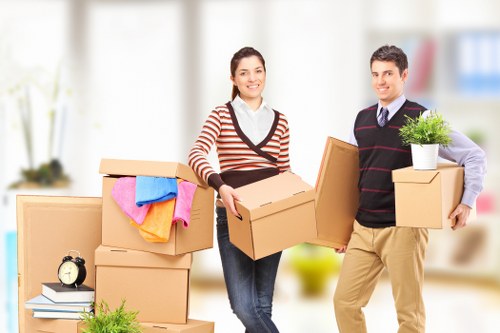 Professional movers handling large furniture items carefully